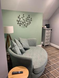 a living room with a couch and a table at The Powfoot Hotel, Annan in Annan