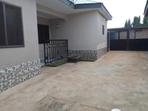a patio outside of a house with a fence at Mixtech Vacation Home -MVH in Sunyani