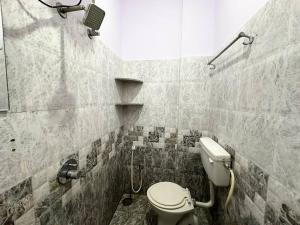 een kleine badkamer met een toilet en een douche bij Amazing AC Studio in E City 3F 301 in Bangalore