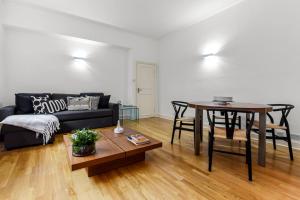 a living room with a couch and a table at 2 Bedroom Apartment- Mayfair (1) in London