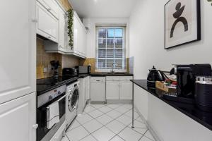 a kitchen with a sink and a dishwasher at 2 Bedroom Apartment- Mayfair (1) in London