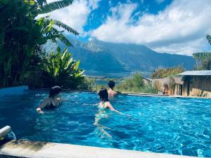 a group of people in a swimming pool at Volcano Living in Kintamani