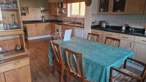 a kitchen with a table with a blue table cloth at Family home three bed house near the beach in Herne Bay