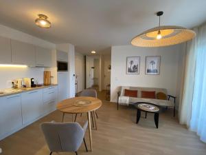 a kitchen and a living room with a table at CAZAM Paris Saint Ouen in Saint-Ouen