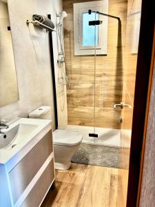 a bathroom with a toilet and a shower and a sink at Barceloneta Ramblas Apartments in Barcelona
