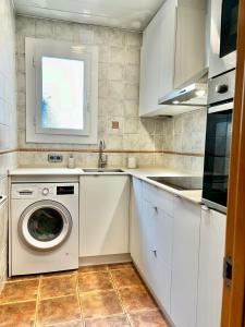 a kitchen with a washing machine and a sink at Barceloneta Ramblas Apartments in Barcelona