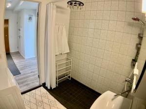 a bathroom with a shower and a toilet and a sink at Kaupunkikoti Apartments 3-room B in Kemi +26 photos