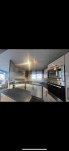 a kitchen with a stove and a microwave at Modern platinum standard 2 bedroom with decking in Rhyl