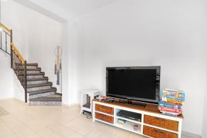 a living room with a flat screen tv on a entertainment center at Ca Xotxim in Altea