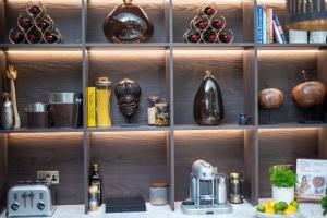 a wooden shelf with various items on it at Cloth Hall Barn & Cottages in Smarden