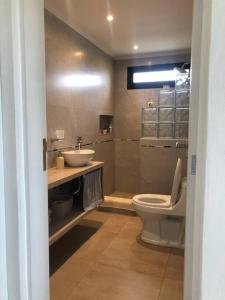 a bathroom with a toilet and a sink at Luna & Playa in Playa Dorada +27 photos