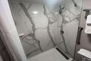 a shower in a bathroom with a marble shower at Days Inn by Wyndham Emporia in Emporia