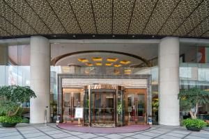 a building with a revolving door in front of it at Wyndham Foshan Shunde in Shunde