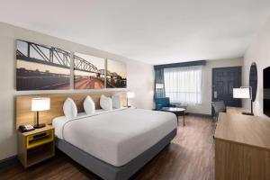 a hotel room with a bed and a desk at Days Inn by Wyndham Carlisle in Carlisle