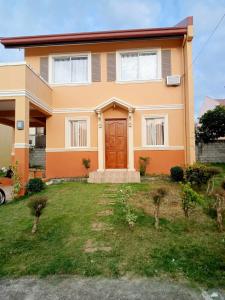 a house with a lawn in front of it at CASITA DE ZACATE in Cagayan de Oro