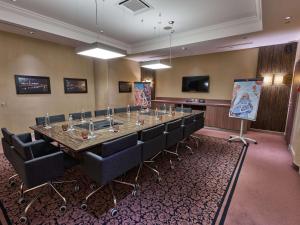 a large conference room with a long table and chairs at Mercure Arbat Moscow in Moscow