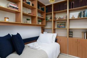 a bedroom with a bed with wooden shelves at Neta's Central Gem with Bomb Shelter in Tel Aviv in Tel Aviv