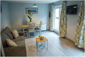 a living room with a couch and a table at Chapel Place, Town Centre in Killarney