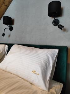 a bedroom with two lights on the wall and a bed at Loft Point 1 