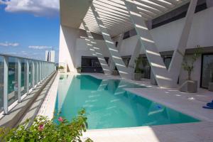 a swimming pool on the roof of a building at Esplendor by Wyndham Asuncion in Asunción