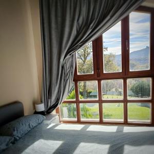 a bedroom with a large window with a view at Eguzkitza in Rentería +1 photo