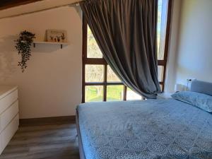 a bedroom with a bed and a large window at Eguzkitza in Rentería