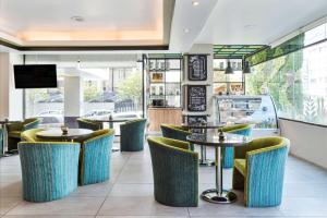 a restaurant with tables and chairs and a window at Wyndham Garden Quito in Quito