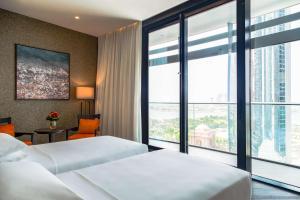 a hotel room with two beds and a large window at Grand Hyatt Abu Dhabi Hotel & Residences Emirates Pearl in Abu Dhabi