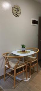 a table and chairs with a potted plant on it at Le Palis Suite 