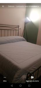 a bedroom with a bed with a light on it at amaRE in Reggio Emilia