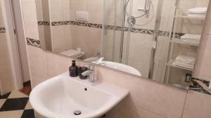 a bathroom with a sink and a shower and a mirror at amaRE in Reggio Emilia