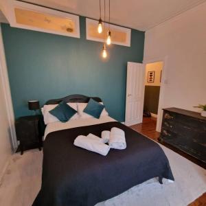 Inviting 3-Bed Apartment in Newcastle upon Tyne في نيوكاسل أبون تاين: غرفة نوم عليها سرير وفوط