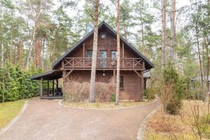 a wooden house in the middle of a forest at Leśna ostoja nad Pilicą in Lechanice