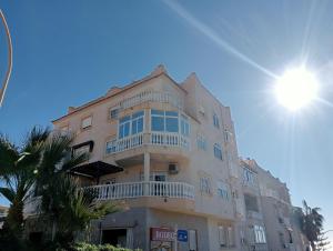 a tall building with a balcony on the side of it at Balcón al mar in Adra