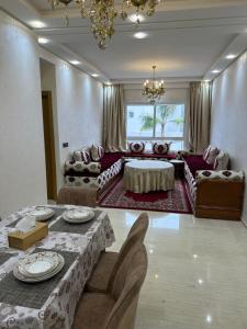 a large living room with a table and chairs at Luxury AÏDA FLAT in Tangier