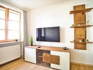 a living room with a flat screen tv on a wall at Ferienwohnung Bergliebe in Berchtesgaden