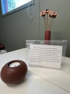 a chocolate donut on a table with a vase of flowers at Borgane 5 in Fjällbacka