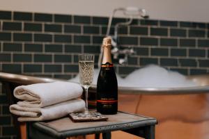 a bottle of champagne and a glass on a table at The Ferry House in Eastchurch