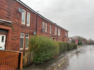 a brick building on the side of a street at Bellshill , Belvidere central upper apartment in Bellshill