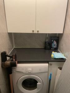 a kitchen with a washing machine under a counter at Bellshill , Belvidere central upper apartment in Bellshill