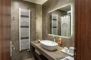 a bathroom with a white sink and a mirror at Samos Tropic Apartments in Ríva