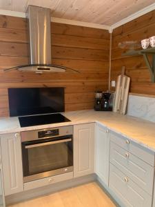 cocina con armarios blancos y fogones en Villa Flo en Stryn