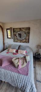 a bedroom with a bed with two bags on it at Le Clos Des Cambres in Les Arcs sur Argens +23 photos
