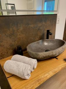 ein Badezimmer mit einem großen Steinwaschbecken und einem Handtuch in der Unterkunft Ferienhaus auffm Hebberg in Attendorn