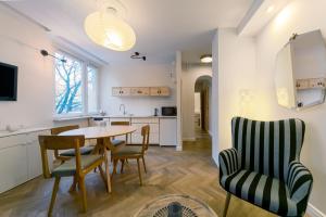 a kitchen and dining room with a table and chairs at Warsaw Concierge Opera II in Warsaw