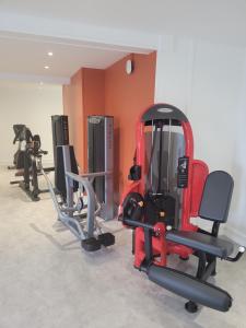 a gym with several exercise equipment in a room at KYRIAD DIRECT LYON NORD - Dardilly in Dardilly