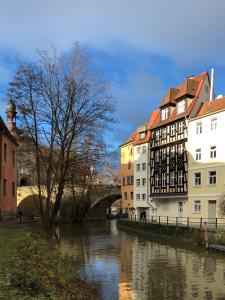 Lofty Luna – großzügig, gemütlich, Galerie! في بامبرغ: نهر في مدينة بها مباني وجسر