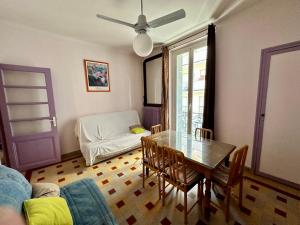 a living room with a table and a couch at APPARTEMENT MAISON, CENTRE VILLE, PROCHE PLAGE TOUT COMMERCE in Menton