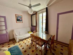 a living room with a table and a couch at APPARTEMENT MAISON, CENTRE VILLE, PROCHE PLAGE TOUT COMMERCE in Menton
