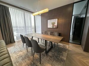 a dining room with a table and chairs at Resident City Hotel in Almaty